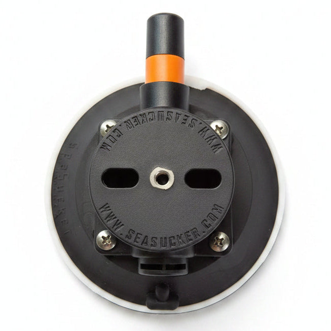 Black and orange electrical plug on a Flat White textured background